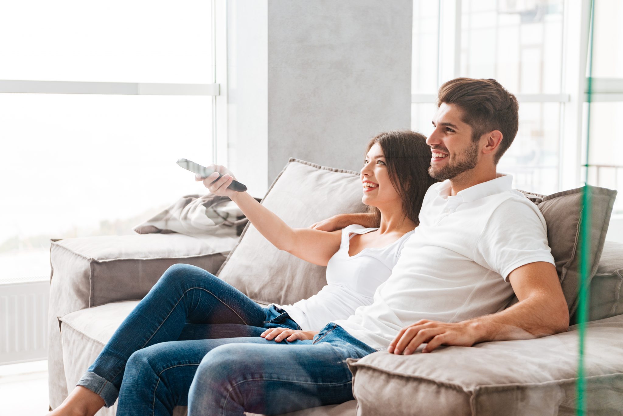 Happy couple enjoying KingVOD IPTV streaming service at home